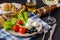 Appetizer with fresh tomatoes and mozzarella and bread and parmesan cheese in the kitchen