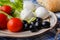 Appetizer with fresh tomatoes and mozzarella and bread and parmesan cheese in the kitchen