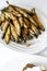 Appetizer of fried sprat and vegetables. White background. Top view
