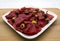 Appetizer of italian bresaola and olives on white plate. Wooden table, white background