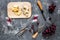 Appetizer parmesan cheese, cheese with blue mould and red grape on grey stone table background top view