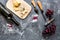 Appetizer parmesan cheese, cheese with blue mould and red grape on grey stone table background top view