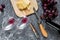 Appetizer parmesan cheese and red grape on grey stone table background top view