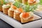 Appetizer puff pastry with dill dip and salmon on stone tray