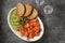 Appetizer - salted salmon, pieces of cucumber, capers, dill and grilled bread. Top view,