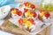 Appetizer. Slices of bread with cottage cheese, multi-colored grilled bell pepper and  olive oilil