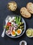 Appetizer, snack, aperitif table - plate of canned tuna, green beans, mozzarella cheese, tomatoes, boiled egg, olives, grilled