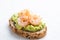 Appetizer toast or bruschetta with avocado cream and shrimps