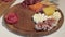 Appetizers boards with assorted cheese, meat, grape and nuts. Charcuterie and cheese platter. Speed Motion