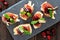 Appetizers with cranberry sauce above on a slate server