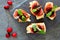 Appetizers with cranberry sauce above on a slate server