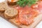 Appetizers - salted salmon, red caviar, toast on wooden board