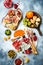 Appetizers table with antipasti snacks. Bruschetta or authentic traditional spanish tapas set, cheese and meat platter