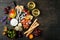 Appetizers table with italian antipasti snacks and wine in glasses. Cheese and charcuterie variety board over rustic wooden table