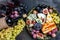 Appetizers table with italian antipasti snacks and wine in glasses. cheese, ham, nuts, fruit, bread sticks. Delicious balanced