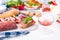 Appetizers table with italian antipasti snacks and wine in glasses. Salami and bruschetta with fresh vegetables on a white