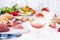 Appetizers table with italian antipasti snacks and wine in glasses. Salami and bruschetta with fresh vegetables on a white