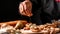 Appetizers table with italian antipasti snacks. Young man preparing appetizer while cooking in the kitchen. Long banner format.