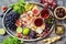 Appetizers table with italian antipasto snacks and wine in glasses on a metal tray. Breadsticks grissini with prosciutto ham, figs