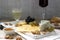 Appetizers of various types of cheese, grapes, nuts and honey, served with white and red wine. Rustic style