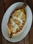Appetizing Adzharian khachapuri with egg and butter.