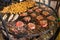 Appetizing barbecued marinated steaks and mushrooms on hot grill