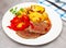 Appetizing beef entrecote with french fries and stewed bell peppers at plate