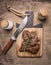 Appetizing beef, grilled, on a cutting board with rosemary, spices and knife for meat wooden rustic background top view close u