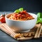 Appetizing bowl of spaghetti with tomato sauce and basil