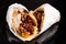 Appetizing burrito filled with a savory combination of beans and meat, wrapped in a soft tortilla