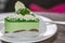 Appetizing cake with kiwi jelly on the plate