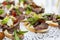 Appetizing canapes with meat and vegetables on the buffet table. Business meetings and celebrations. Close-up. Selective focus