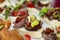 Appetizing canapes with meat and vegetables on the buffet table. Business meetings and celebrations. Close-up. Selective focus