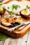 Appetizing canapes or sandwiches with smoked salmon. Toast with salted fish, cheese, egg, onion rings and fresh salad