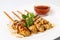 Appetizing Caucasian dish, meat kebab-lamb with sauce on white p
