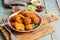 Appetizing chicken nuggets with different sauces on a green rustic wooden table. Selective focus.