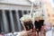 Appetizing coffee ice cream in female hands over Pantheon city view, Rome, Italy. Tasty ice cream like a symbol of summer and