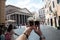 Appetizing coffee ice cream in female hands over Pantheon city view, Rome, Italy. Tasty ice cream like a symbol of summer and