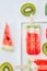 Appetizing composition of ice lolly on a stick and juicy pieces of watermelon and kiwi on a gray marble background with