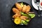 Appetizing crispy chicken wings breaded with bread crumbs with lettuce, sauce, lemon, microgreens in a plate on the