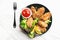 Appetizing crispy chicken wings breaded with bread crumbs with lettuce, sauce, lemon, microgreens in a plate on the