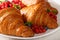 Appetizing crispy croissants and berries macro on a plate. horiz