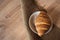 An appetizing croissant lies in a saucer on a fabric, on a table