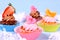 Appetizing cupcakes with angel, heart, tangerine, strawberry