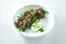 Appetizing and dietary salad of baked beetroot, arugula and microgreen with green butter and white sauce in a