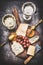 Appetizing fine cheese selection on rustic plate with wine, grape and Honey mustard sauce