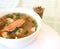 Appetizing fish soup with pieces of red fish.