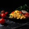 Appetizing fresh tasty omelet with tomatoes, isolated on black background close-up, great breakfast dish,