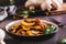 Appetizing fried champignons and basil leaves on a plate on the table