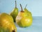 Appetizing green pears on a blue background